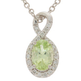 Oval green peridot pendant in 14K yellow gold with diamond accents, elegant jewelry piece for any occasion.